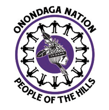 Onondaga Nation: People of the Hills image of people holding hands in a circle around the head of a person in traditional Onondaga dress. The image is in black, white, and purple.